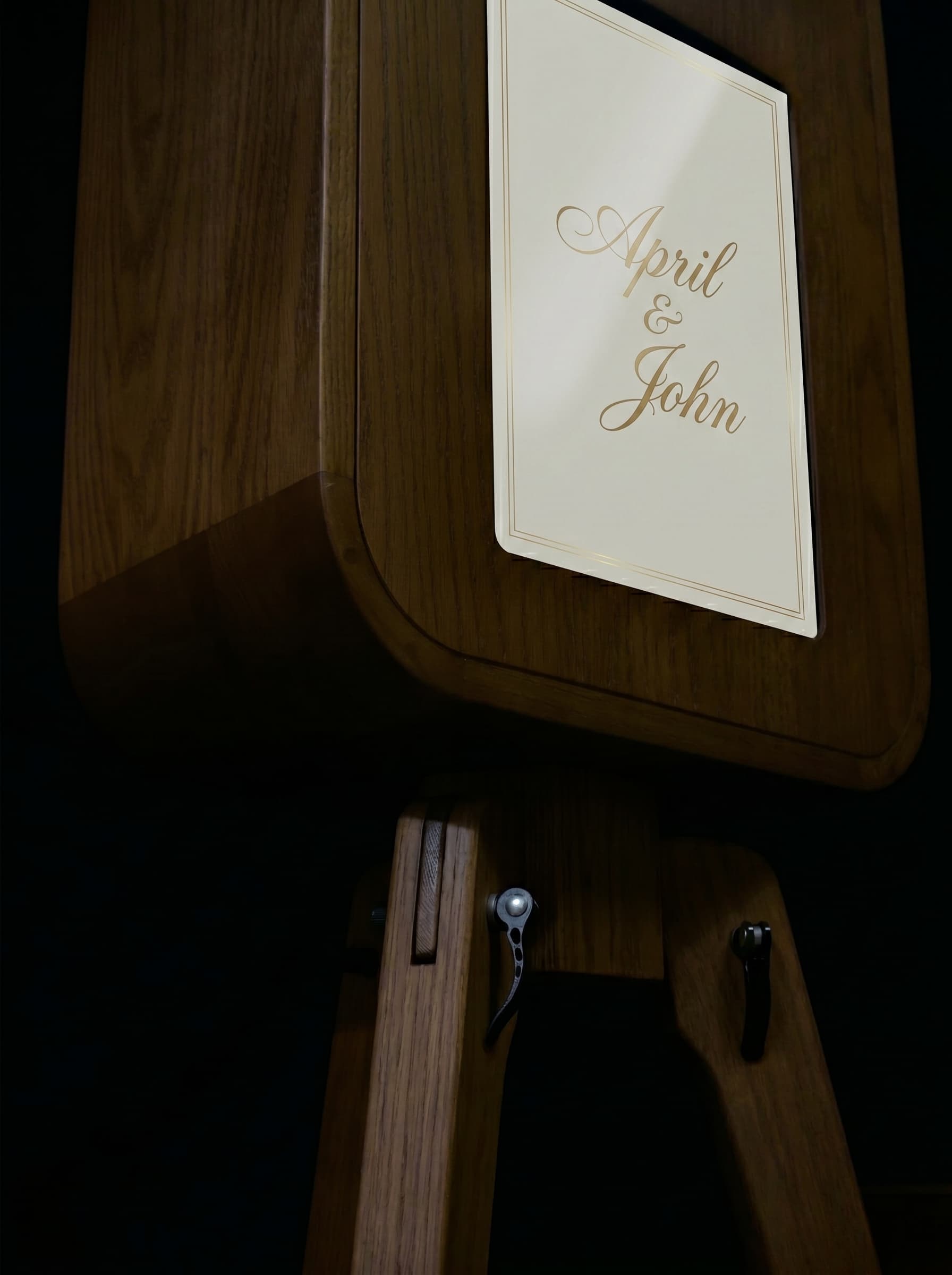 Close view of an oak booth screen personalized with a couple's names